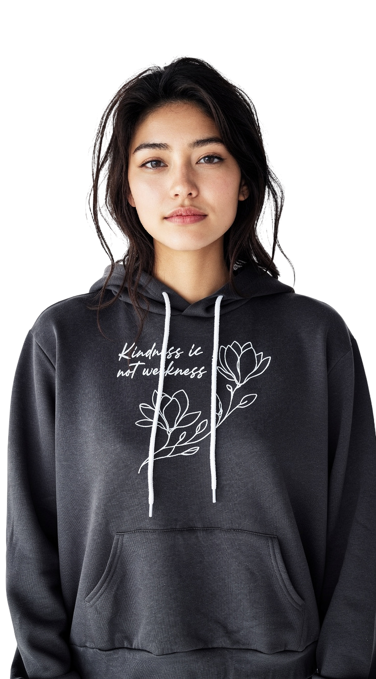A young woman with long dark hair models the RainBee Designs LLC “Kindness is Not Weakness Hoodie,” featuring white drawstrings, floral line art, and inspiring text. She stands against a plain white background.