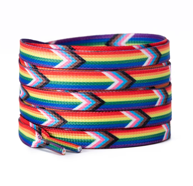 The Pride Shoelace Pack by RainBee Designs LLC features coiled shoelaces with vibrant rainbow and chevron patterns, incorporating colors from the LGBTQ+ pride flag—including black, brown, white, pink, and blue stripes. These colorful shoelaces offer a fun way to express your individuality and proudly show your support.