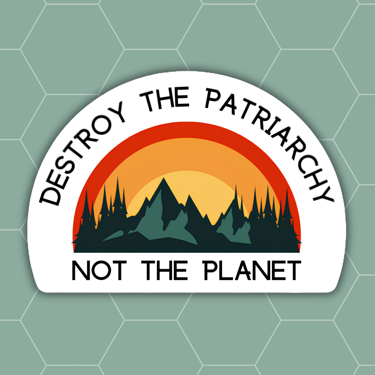 A die-cut sticker with a white border featuring the text 'DESTROY THE PATRIARCHY NOT THE PLANET' in black around a stylized sunset and mountain landscape graphic in orange, yellow, and dark green, shown on a muted green hexagonal background.