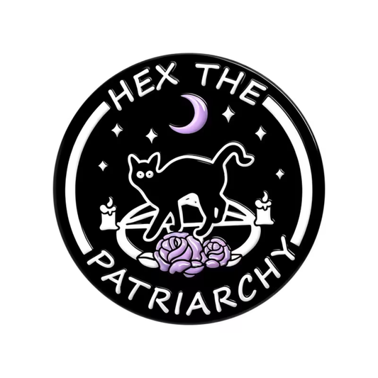 The Hex the Patriarchy Pin by RainBee Designs LLC is a black circular activism lapel pin featuring the bold “HEX THE PATRIARCHY” text and a witchy cat enamel design with candles, purple roses, stars, and a crescent moon—perfect for adding mystical vibes to your look.