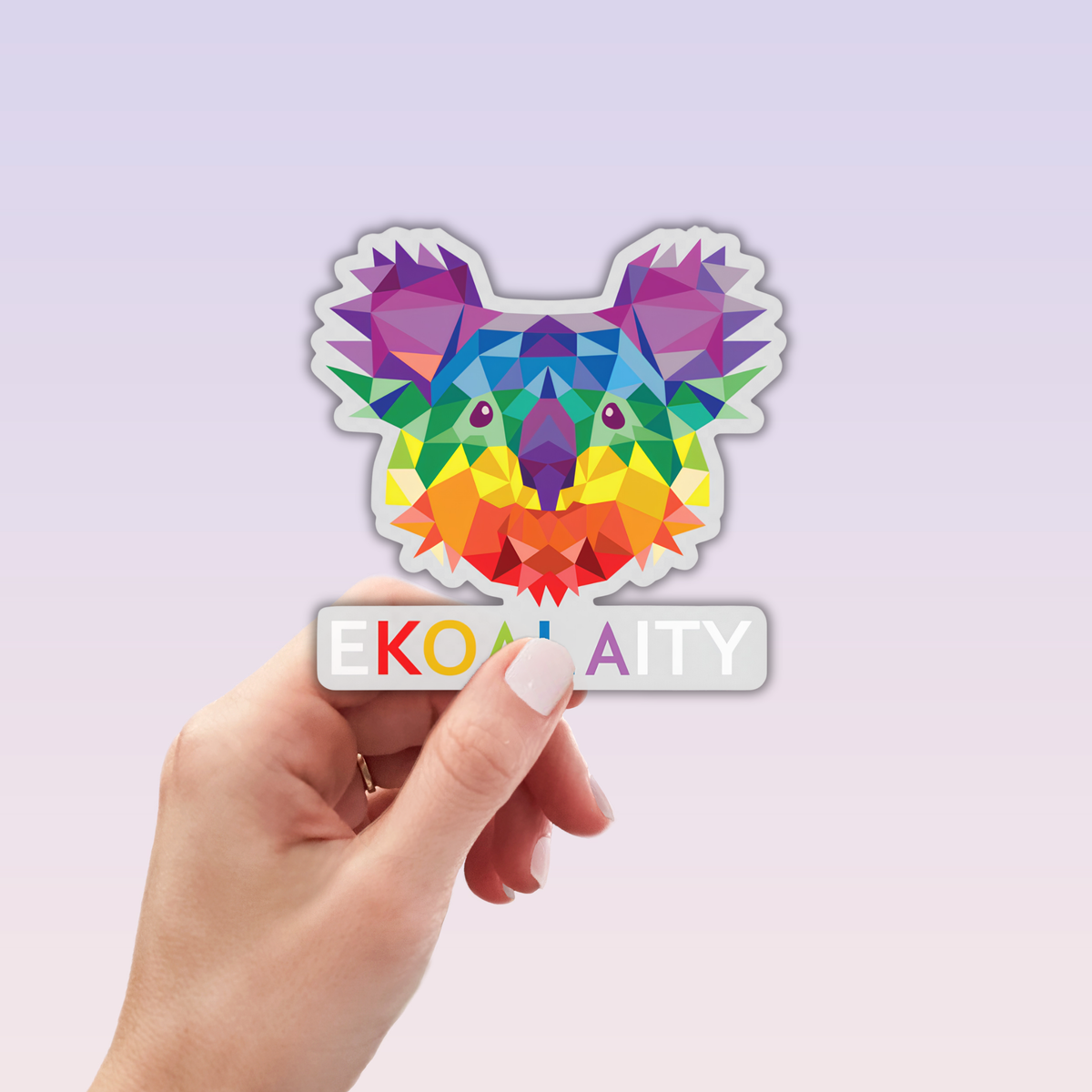 A hand holds a small card displaying the eKOALAity Sticker by RainBee Designs LLC—a colorful geometric animal sticker, ideal as a laptop or waterproof vinyl sticker.