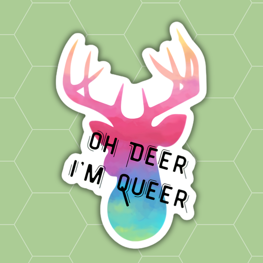 A die-cut sticker featuring a stylized deer head with pink, purple, and blue watercolor shading and the text 'OH DEER I'M QUEER' in black outlined lettering, shown on a light green hexagonal background.