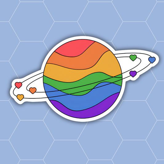 A die-cut vinyl sticker of a stylized rainbow planet with rings and small heart-shaped moons, shown on a light blue hexagonal patterned background.