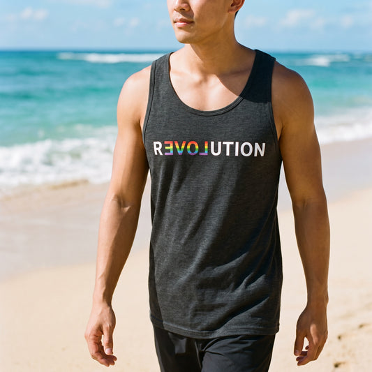 A person wearing a black Revolution Tank Top by RainBee Designs LLC, featuring rainbow colors, walks along a sandy beach by the ocean on a sunny day.