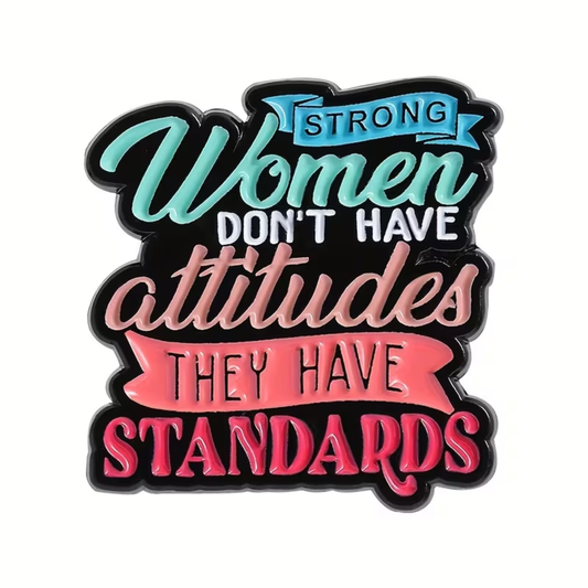 Show your support for powerful women with the Strong Women Have Standards Pin by RainBee Designs LLC. This vibrant enamel pin features bold script reading, “Strong women don’t have attitudes, they have standards,” with eye-catching blue and pink banners emphasizing the words “strong” and “standards.” It’s the perfect accessory to inspire confidence and celebrate strength wherever you go.