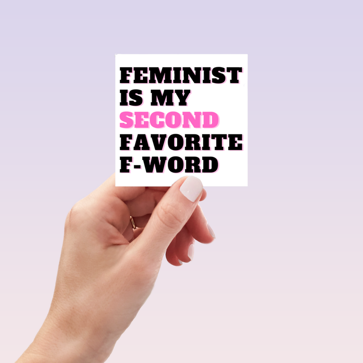 A hand with light pink nail polish holds the Feminist Sticker by RainBee Designs LLC, featuring "Feminist is my second favorite F-word" with "second" in pink, against a light purple gradient background.